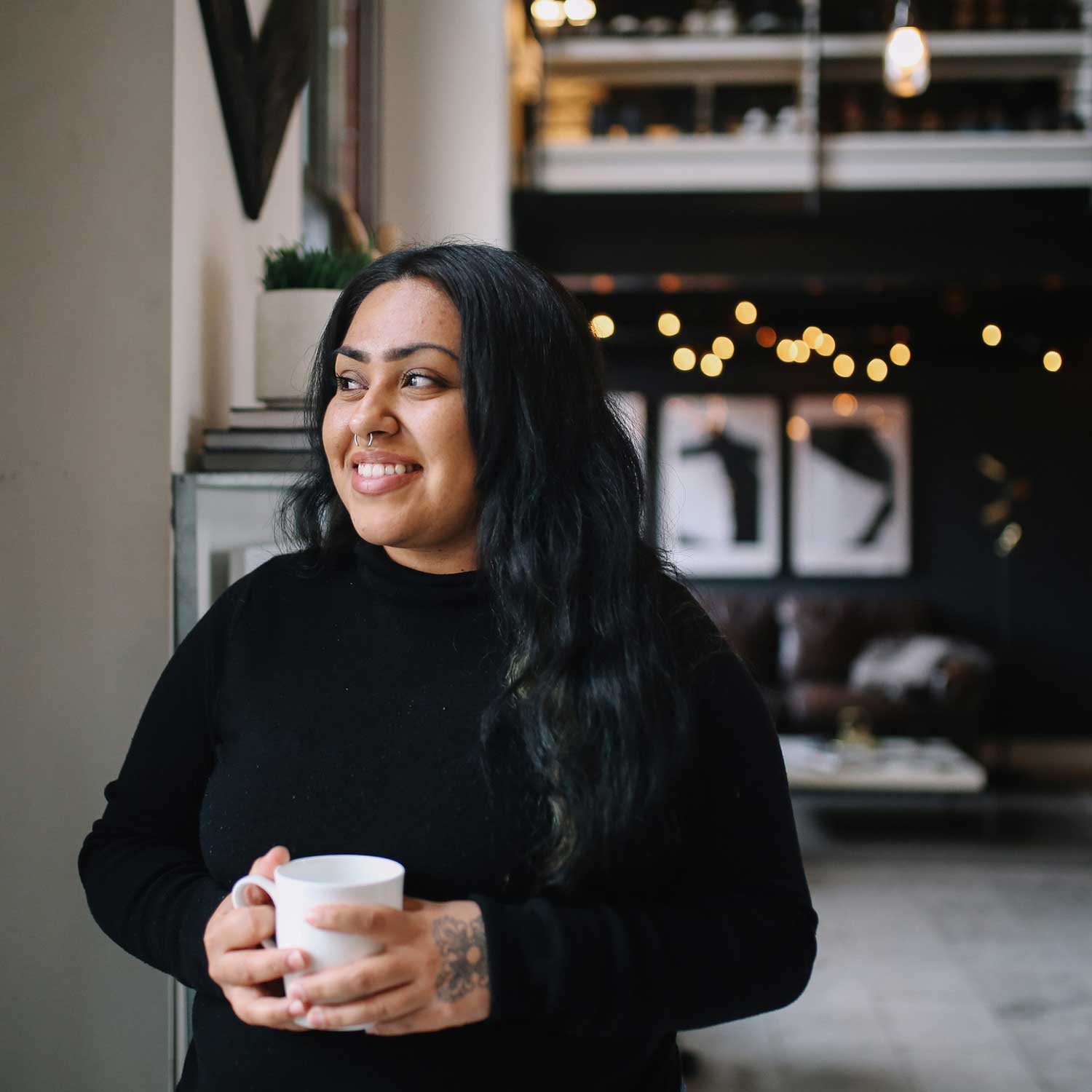 A freelance worker having coffee and smiling