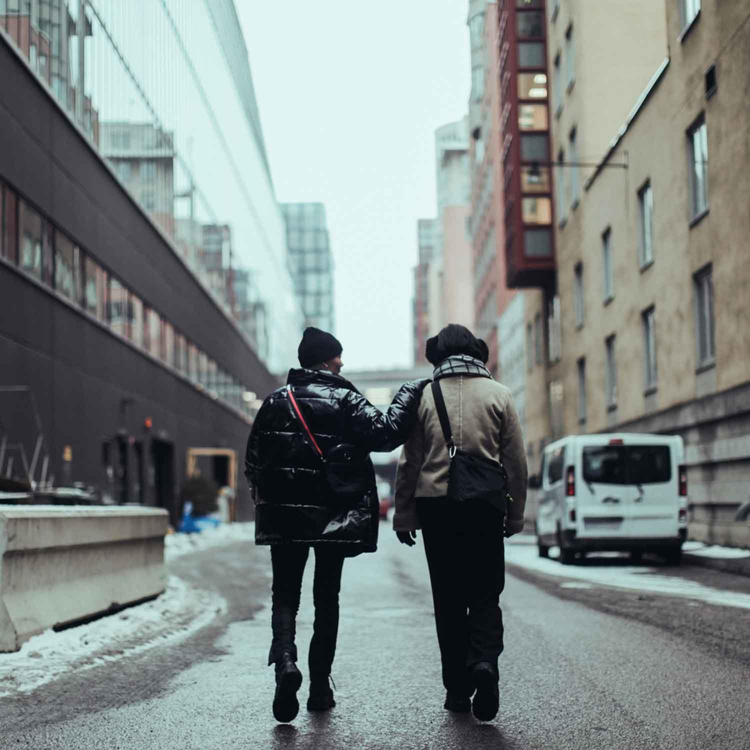 Two freelancers walking together down a city street
